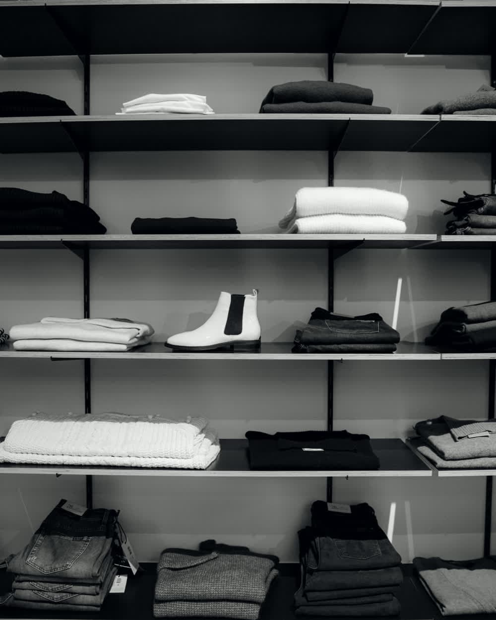 Folded stock stacked on the shelves of a garment showroom